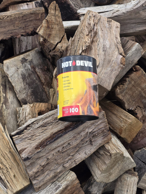 Hot Devil Firelighters - 100 Pack surrounded by mixed hardwood